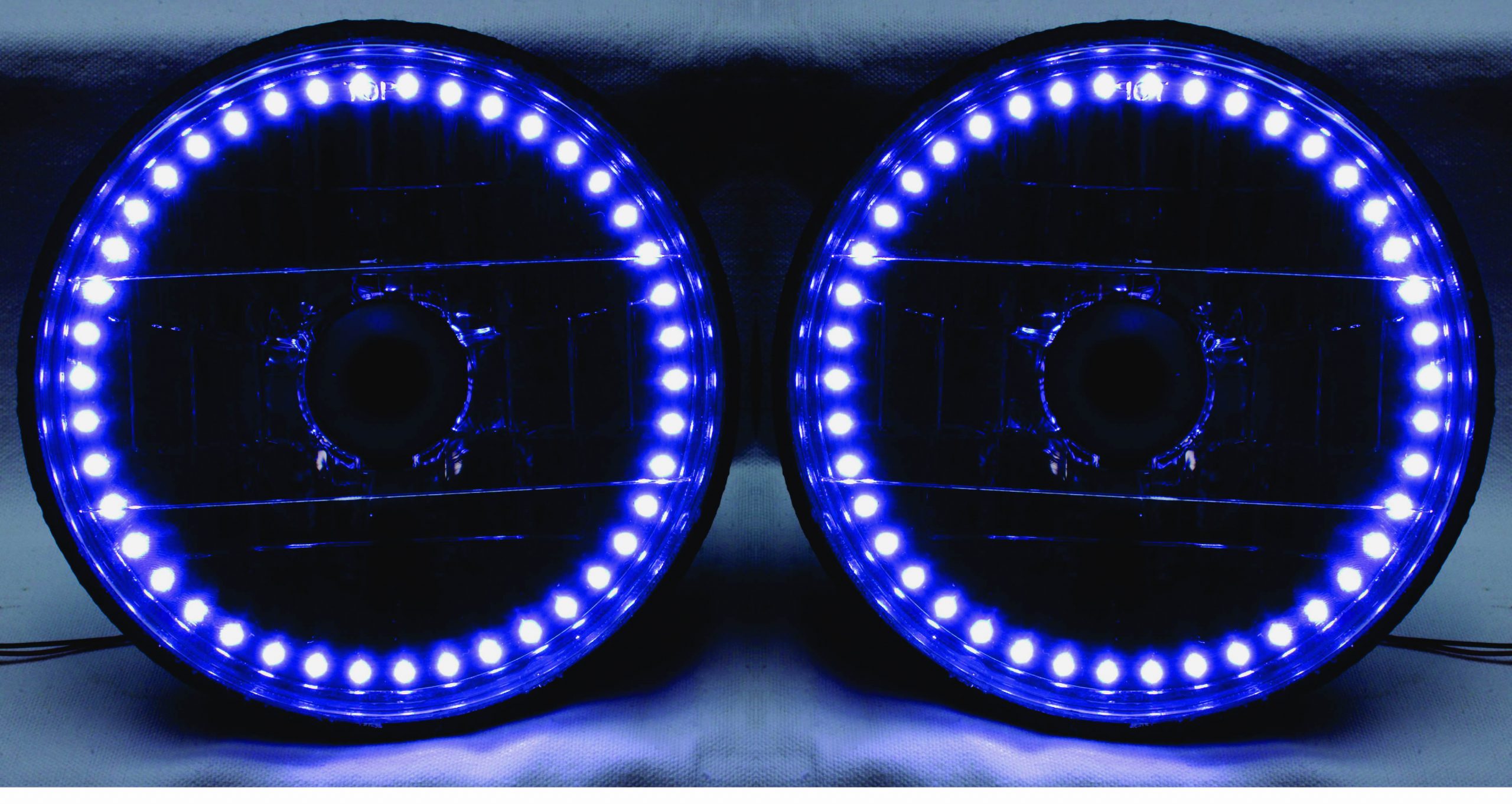 One Pair of 7 Inch Round White Diamond Single Color White Halo Black Illusion ™ Headlights with Clear Halogen Bulbs