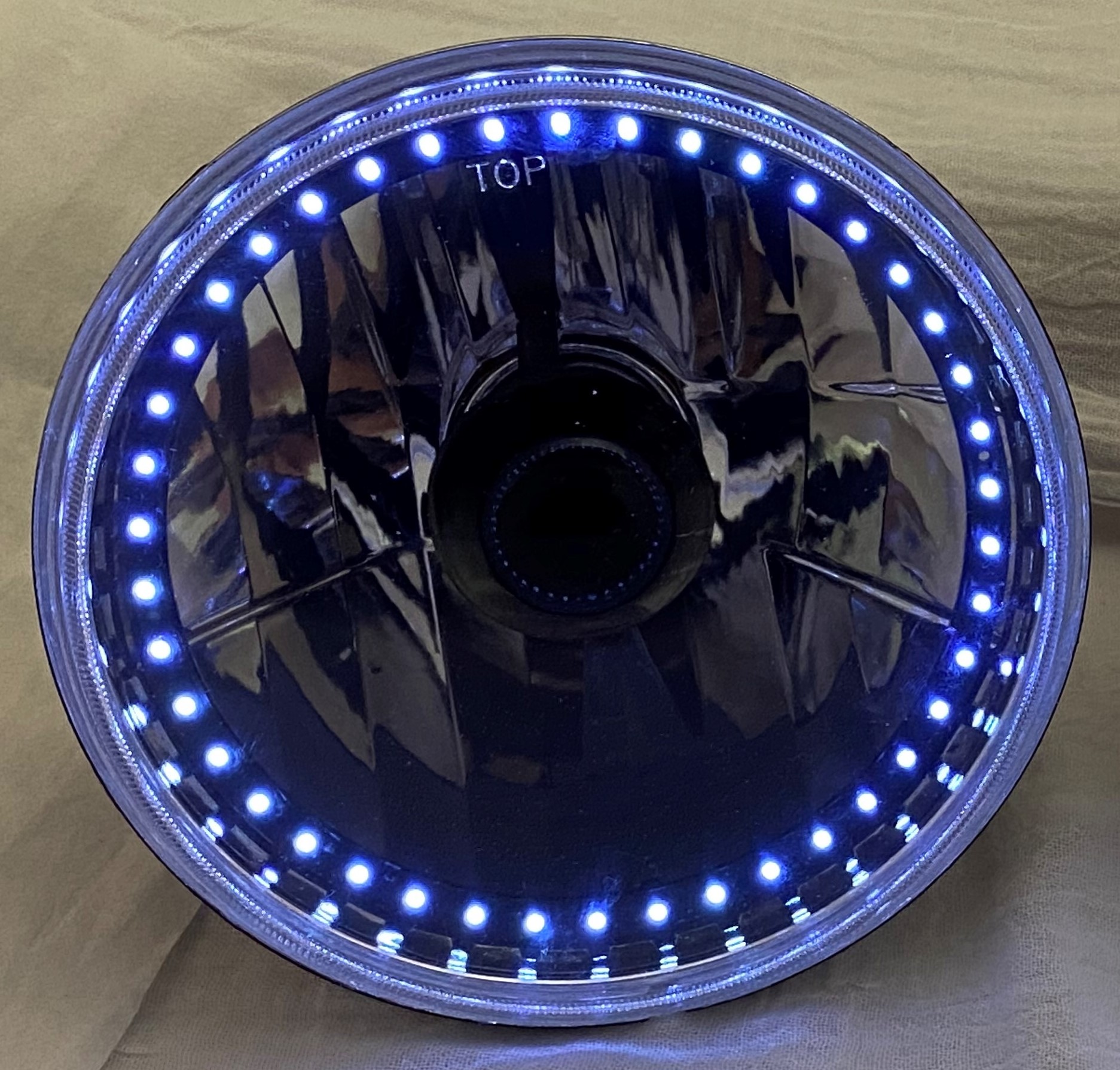 One Each of 7 Inch Round Elite Diamond Single Color White Halo Black Illusion ™ Headlight with a Clear Halogen Bulb